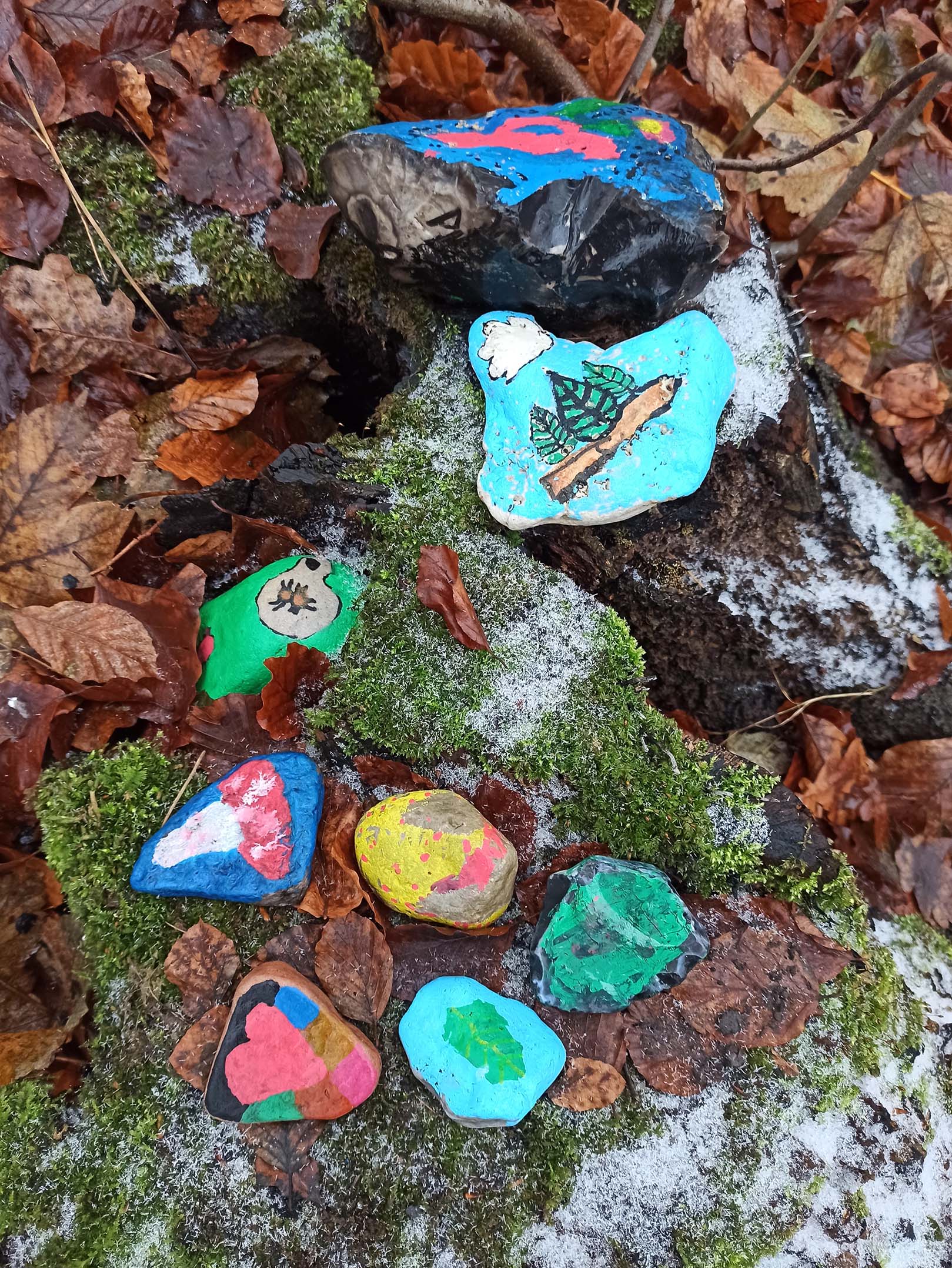 Painted stones on a tree stump